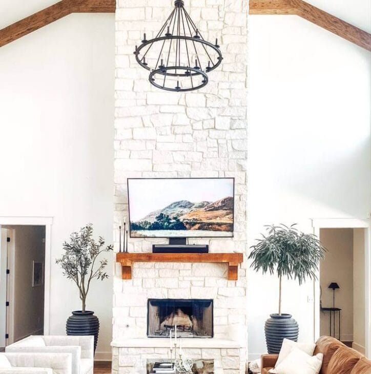 a corner fireplace with a chandelier