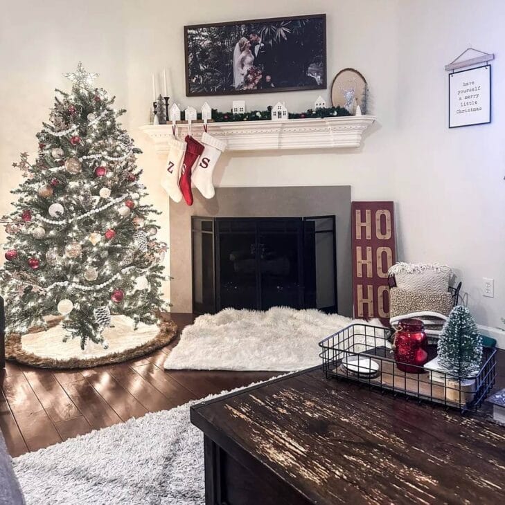 a corner fireplace with christmas decor