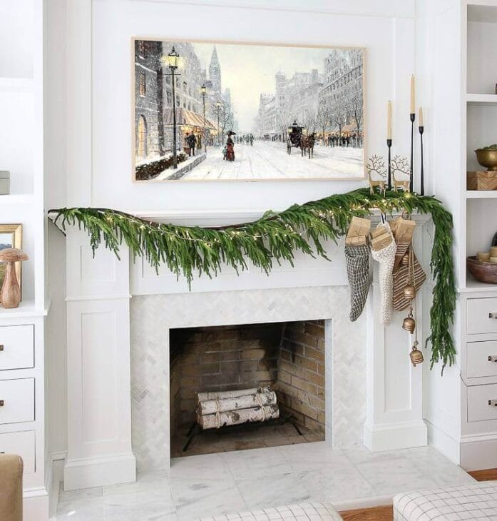 a fireplace mantel with a winter-themed art placed above it