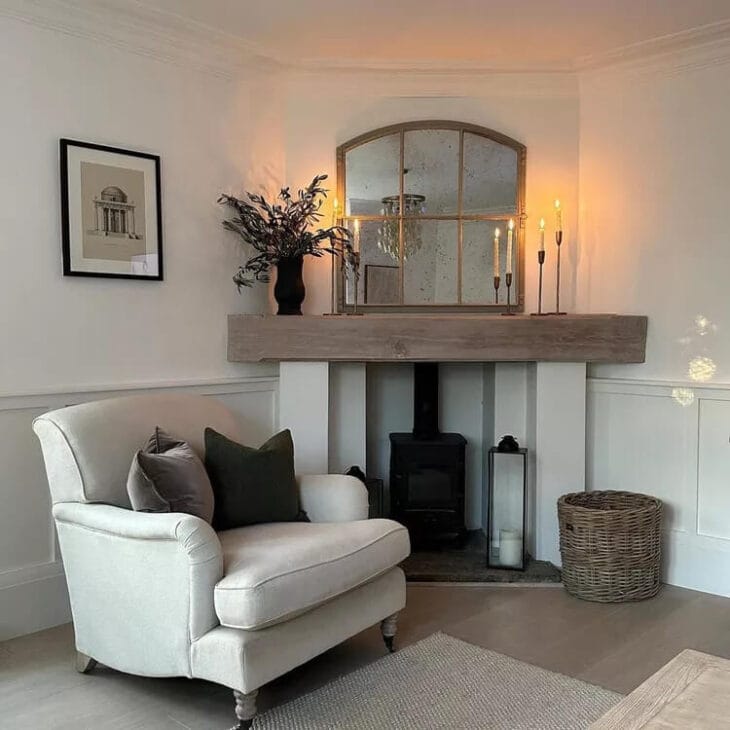 a statement mirror above a corner fireplace