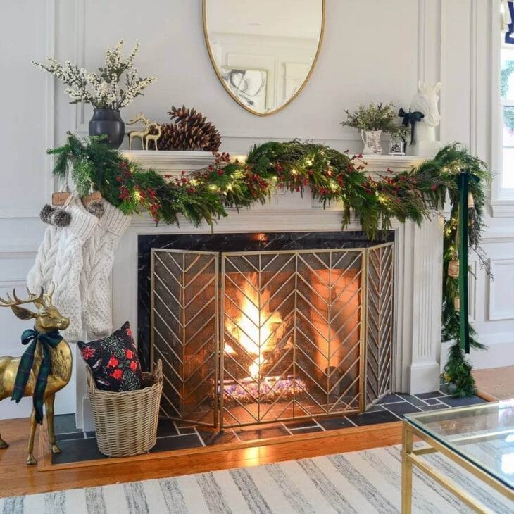 a winter fireplace mantel decorated with simple greenery