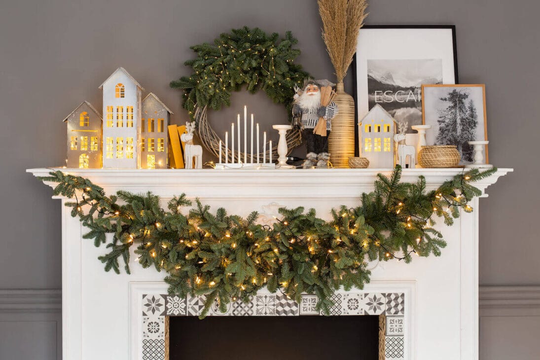 a winter mantel decor with some pinecones, branches and dried leaves